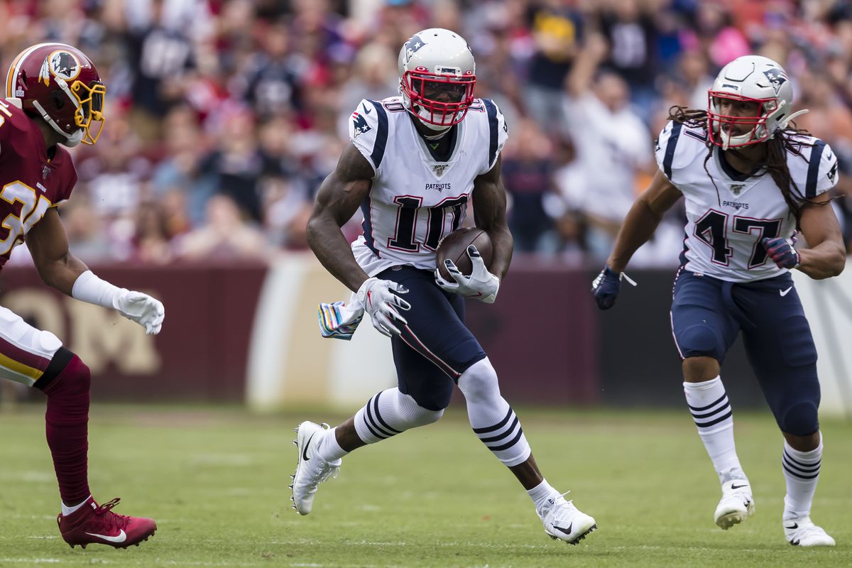 Josh Gordon of the New England Patriots runs after a catch as Montae Nicholson of Washington defends during the first half at FedExField on October 6, 2019 in Landover, Maryland.
