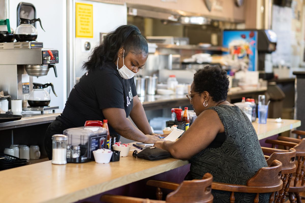 A Serving Spoon server takes an order in Inglewood, California