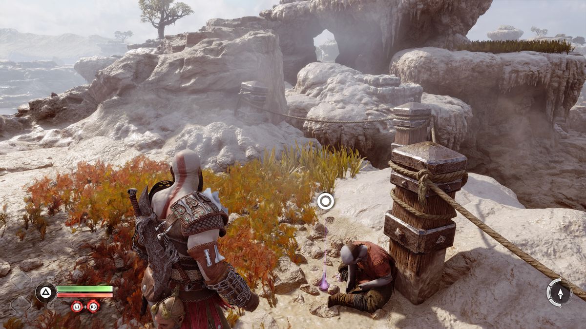 Kratos grabs and artifact from a dead dwarf in God of War Ragnarök