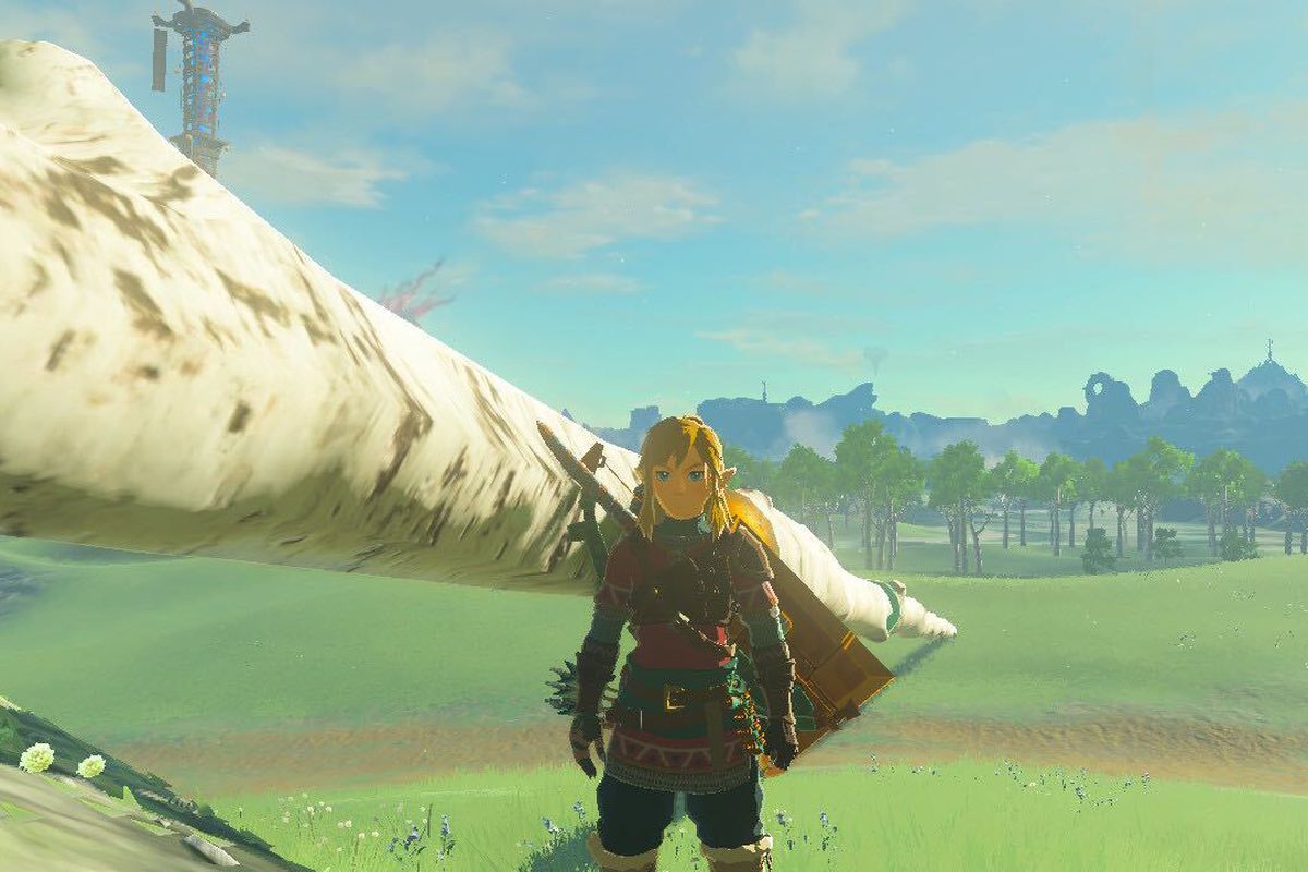 An image of Link in The Legend of Zelda: Tears of the Kingdom standing next to a very long bridge made with the Ultrahand ability. 