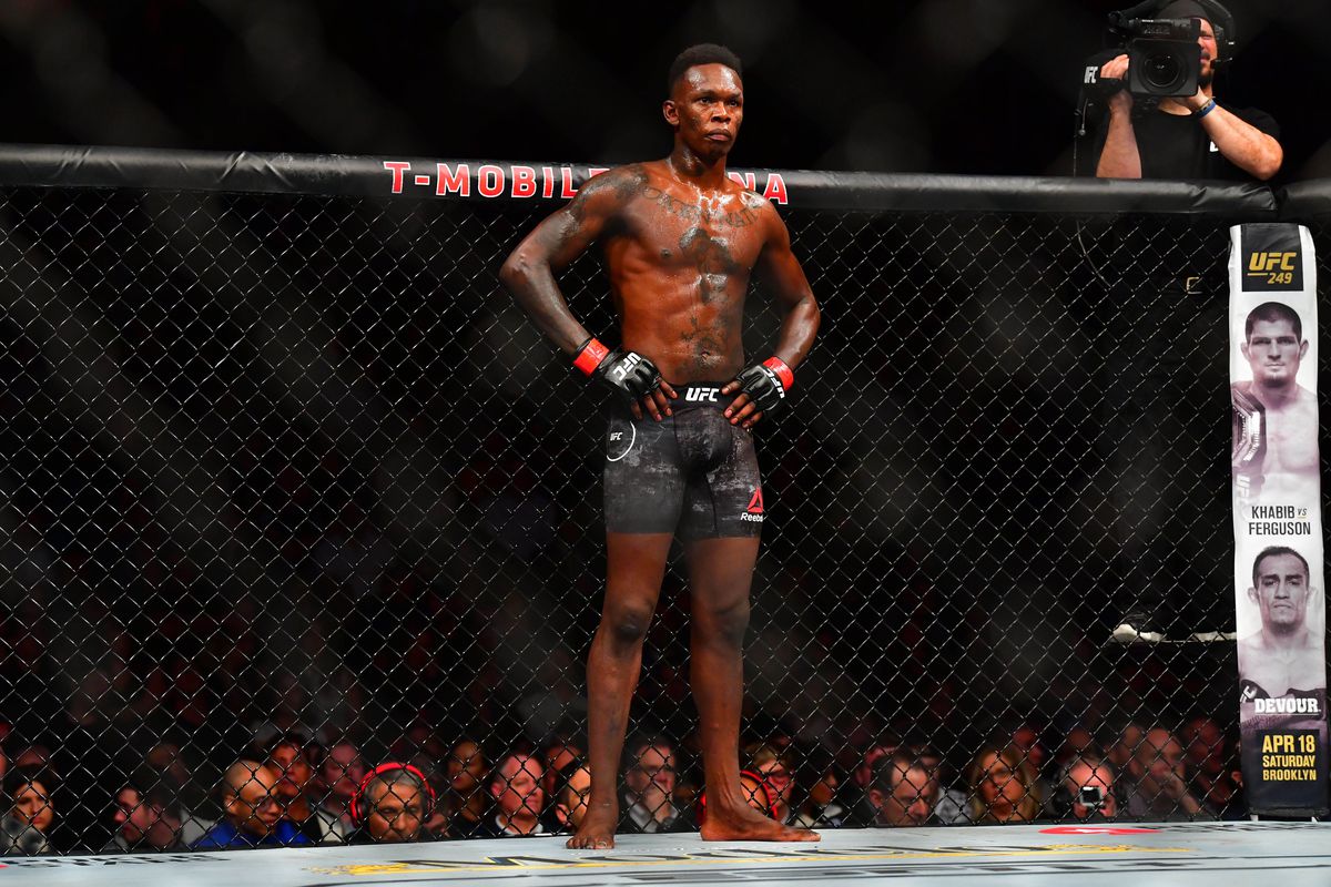 Israel Adesanya (red gloves) fights Yoel Romero (blue gloves) during UFC 248 at T-Mobile Arena.