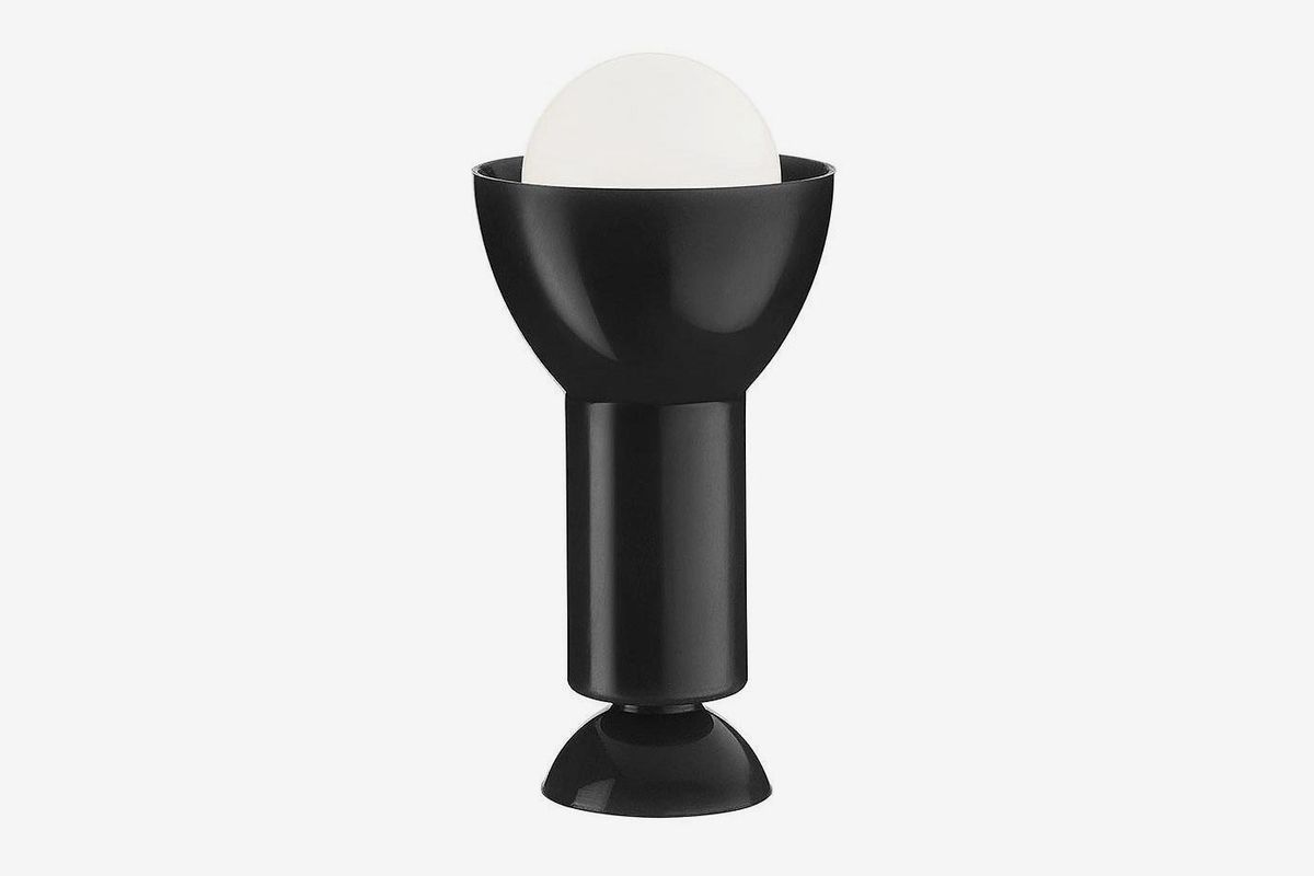 Upright black lamp with white bulb. 