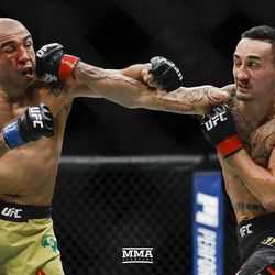 Max Holloway hits Jose Aldo with a right at UFC 218.