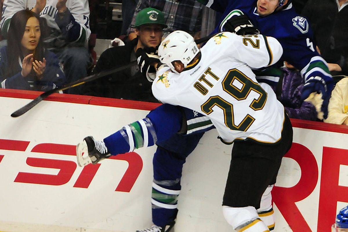 Mar 30, 2012; Vancouver, British Columbia, CANADA; Dallas Stars forward Steve Ott (29) checks Vancouver Canucks defenseman Marc-Andre Gragnani (5) during the first period at Rogers Arena. Mandatory Credit: Anne-Marie Sorvin-US PRESSWIRE