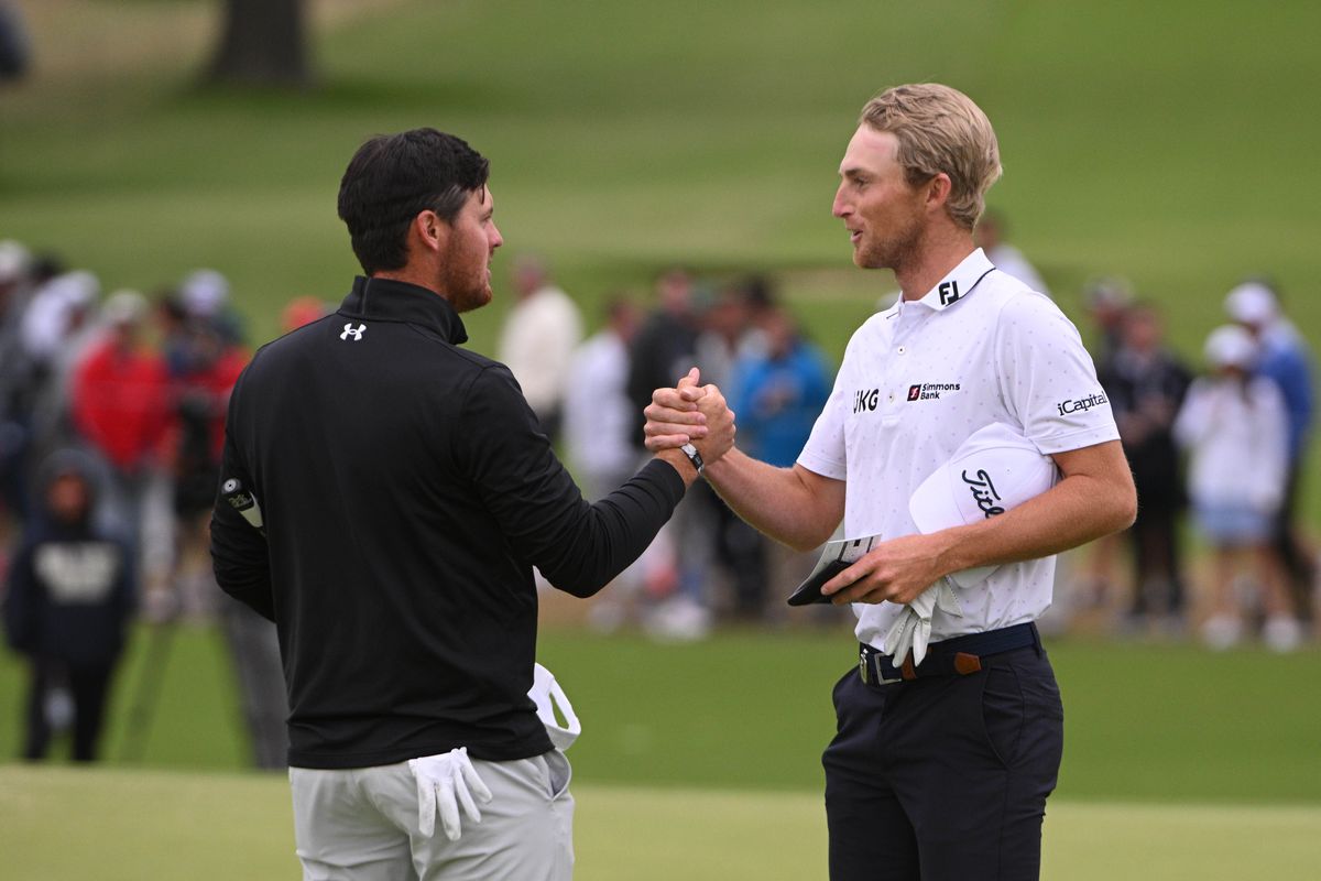 Mito Pereira shakes hands with Will Zalatoris after putting on the 18th green during the third round of the PGA Championship golf tournament at Southern Hills Country Club.