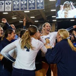 BYU players celebrate their win against Utah after a NCAA volleyball game at Smith Fieldhouse in Provo on Saturday, Dec. 4, 2021.