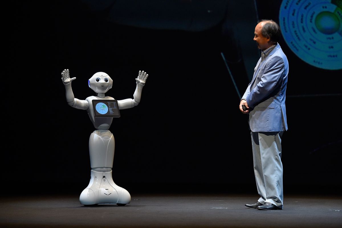SoftBank CEO Masa Son onstage with Pepper the humanoid robot assistant.