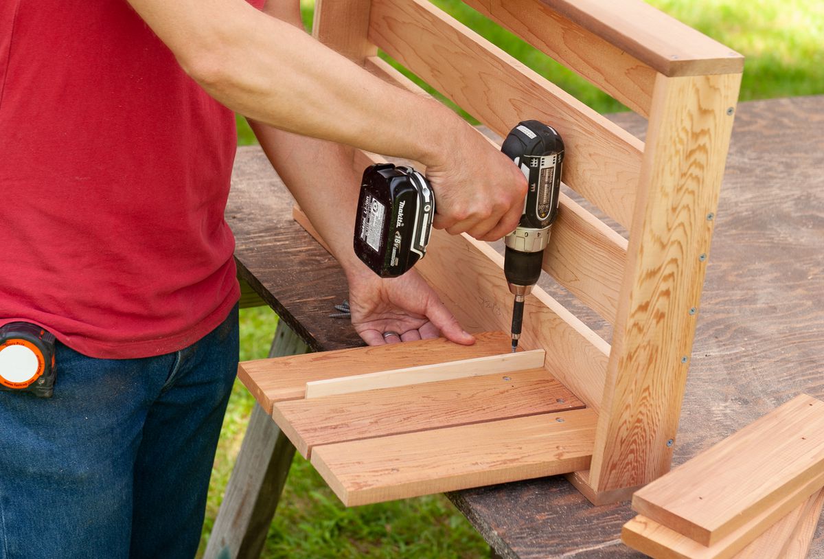 Man Attaches Side Slats For Box Of Cedar Ice Chest Cooler
