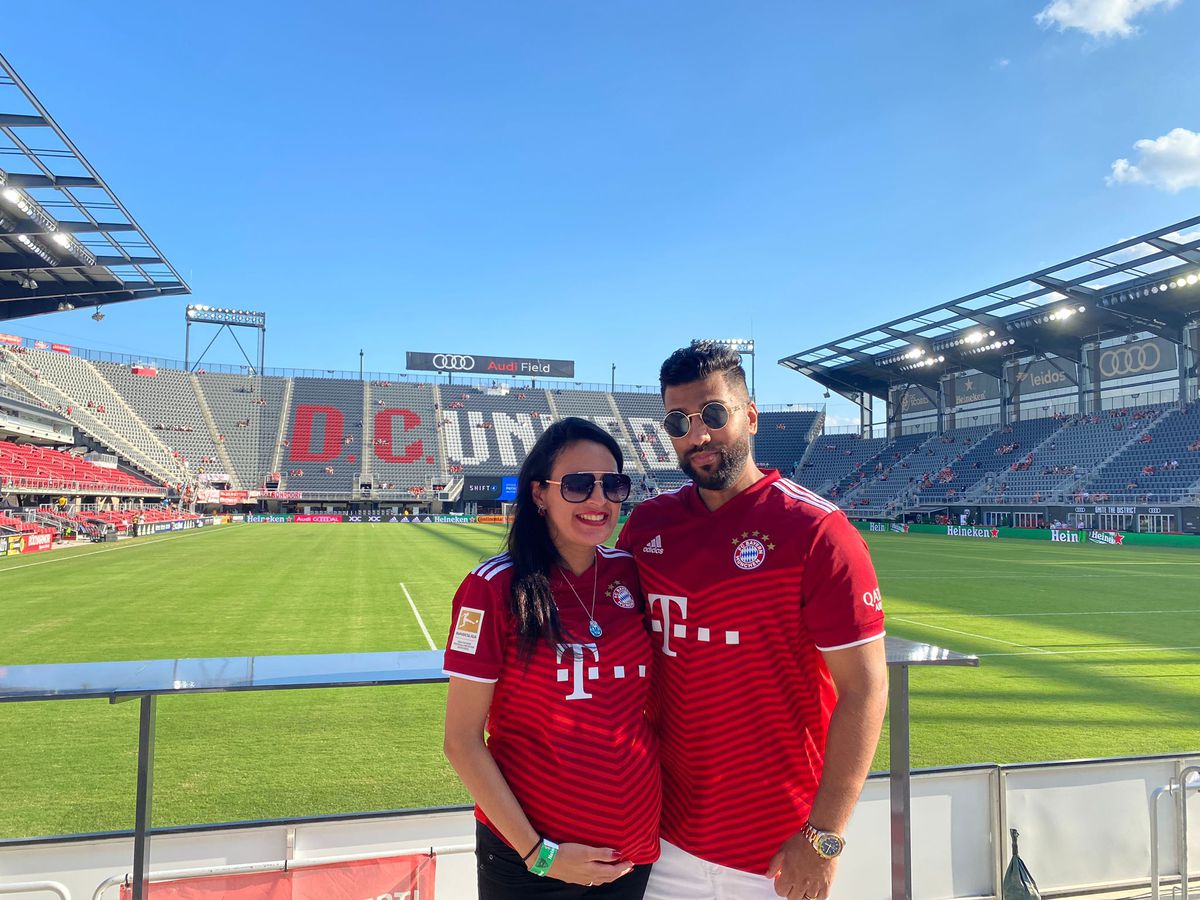 Mr. and Mrs. Soundz pose in front of Audi Field at a mostly-empty stadium before the game.