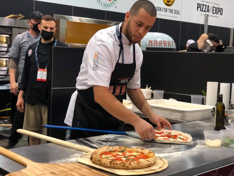 A chef making pizza.