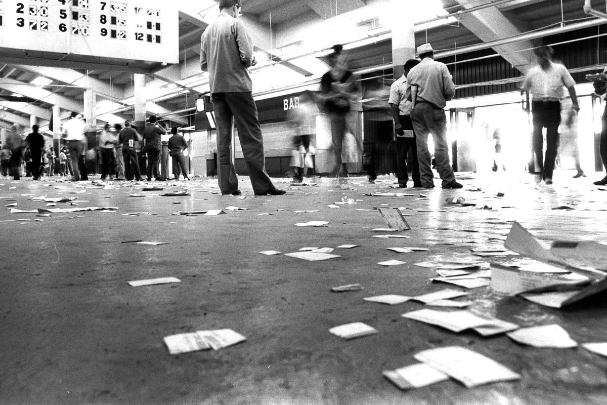 Nov 1983 - Race slips litter the floor of the betting window at Suffolk Downs. Boston Herald staff photo