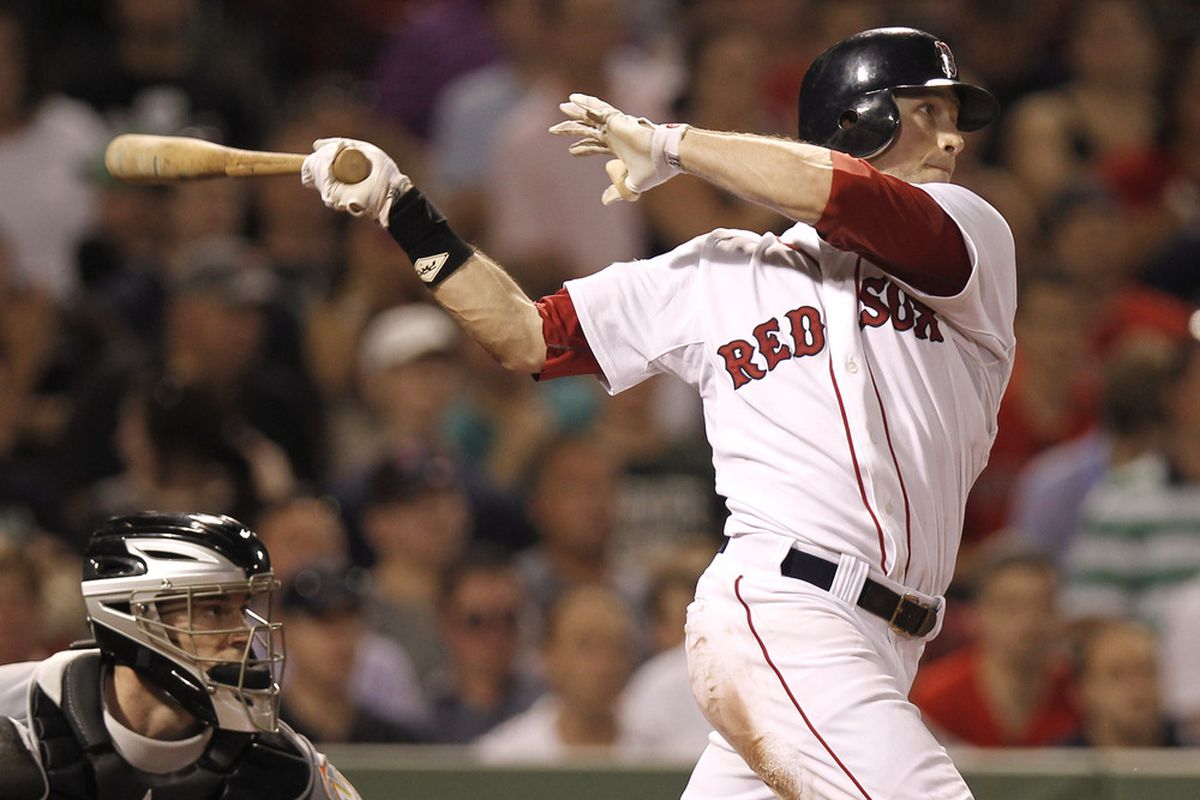  Daniel Nava #66 of the Boston Red Sox and catcher Brett Hayes #9 of the Miami Marlins watch Nava's RBI single to put the Red Sox in the lead during the eighth inning of the game at Fenway Park.  (Photo by Winslow Townson/Getty Images)