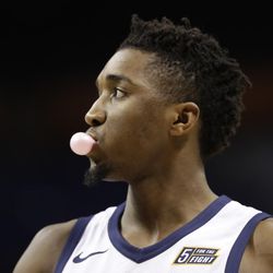 Utah Jazz's Donovan Mitchell blows a bubble as he warms up before an NBA basketball game against the Charlotte Hornets in Charlotte, N.C., Friday, Jan. 12, 2018. (AP Photo/Chuck Burton)