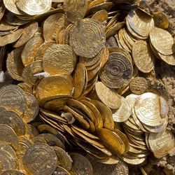 This photo shows a detail of Fatimid period gold coins that were found in the seabed in the Mediterranean Sea near the port of Caesarea National Park in Caesarea, Israel, Wednesday, Feb. 18, 2015. A group of amateur Israeli divers have stumbled upon the largest collection of medieval gold coins ever found in the country, dating back to the 11th century and likely from a shipwreck in the Mediterranean Sea. 