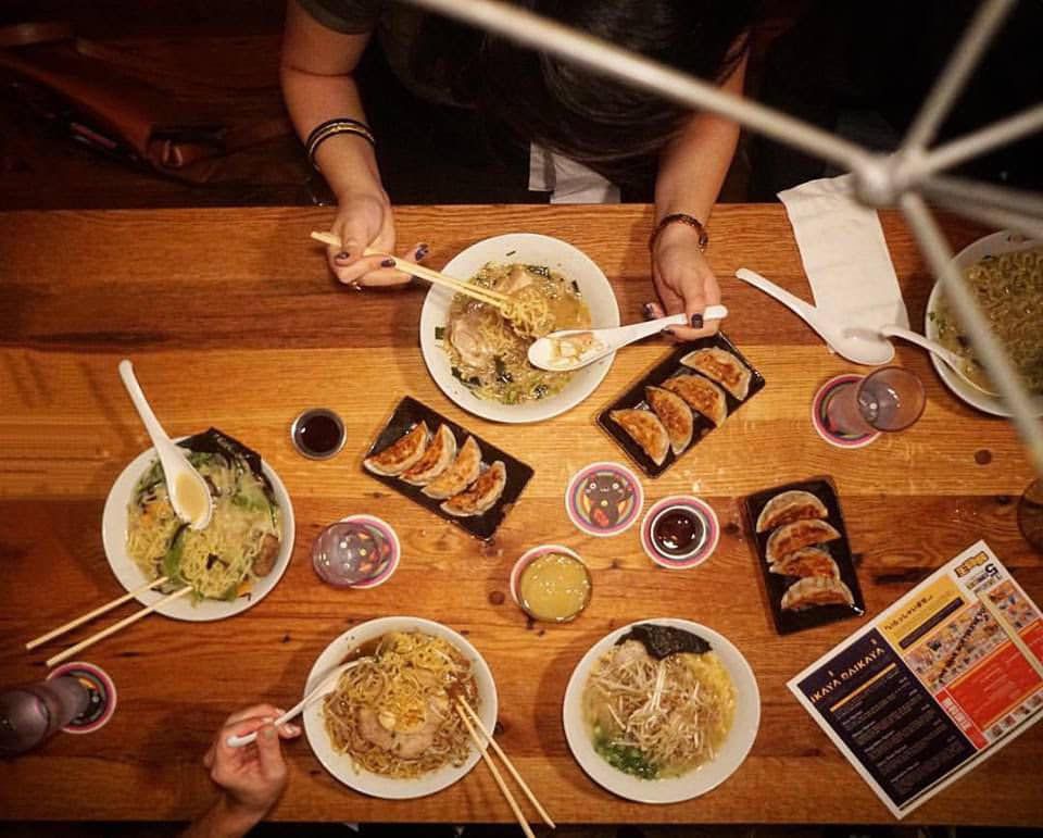a table set with ramen and dumplings