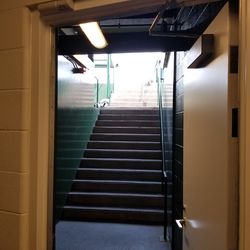 Steps into dugout from walkway next to clubs