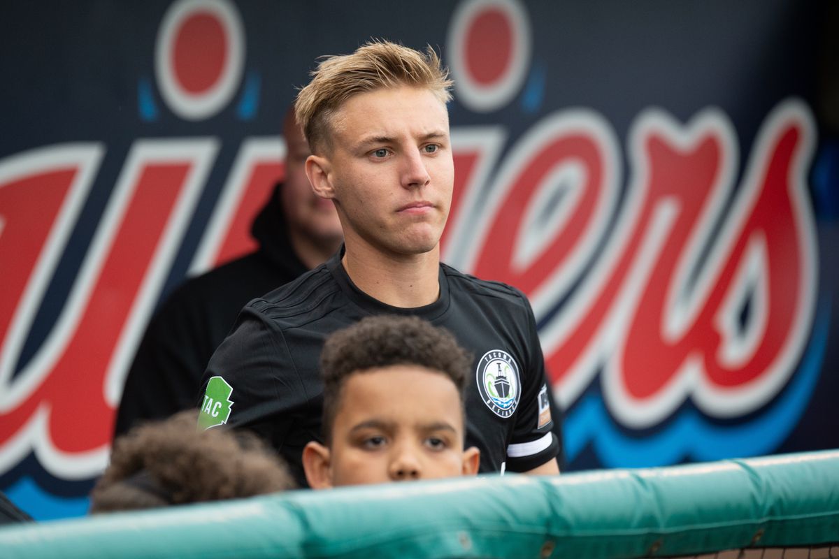 Jesse Daley stands ready to walk out with a youth club prior to a match at Cheney Stadium.