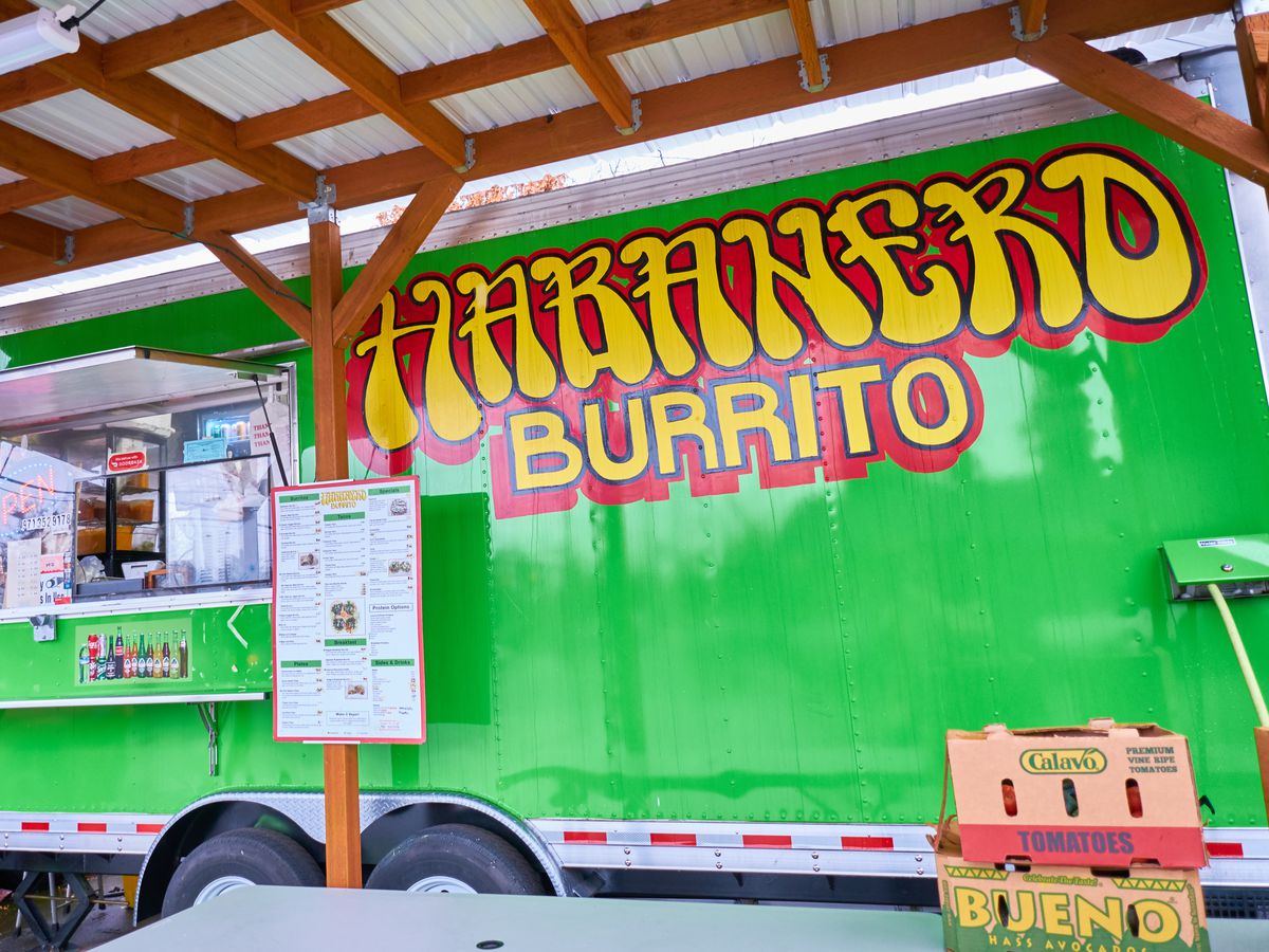 A green food cart open for business, with bright red and yellow lettering reading “Habanero Burrito.”