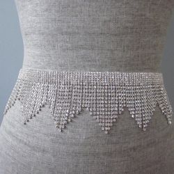 <b>6. Art Deco Silver Rhinestone Flapper Fringe Belt, <a href="https://www.etsy.com/listing/160686141/art-deco-silver-rhinestone-fringe?ref=shop_home_active_6">$200</a></b> on Etsy. Inject some personality into your dress with this cool fringe rhinestone 