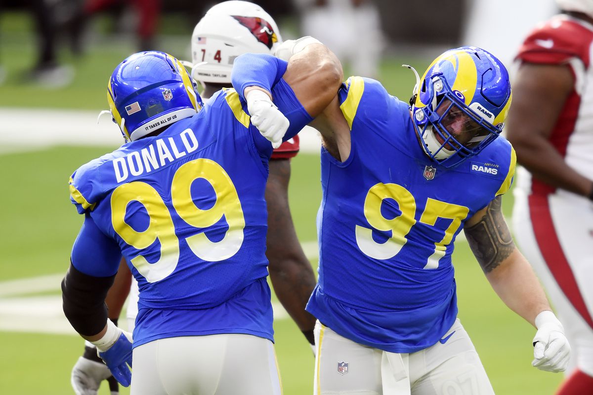 Aaron Donald #99 celebrates with Morgan Fox #97 of the Los Angeles Rams after a defensive play during the first half against the Arizona Cardinals at SoFi Stadium on January 03, 2021 in Inglewood, California.