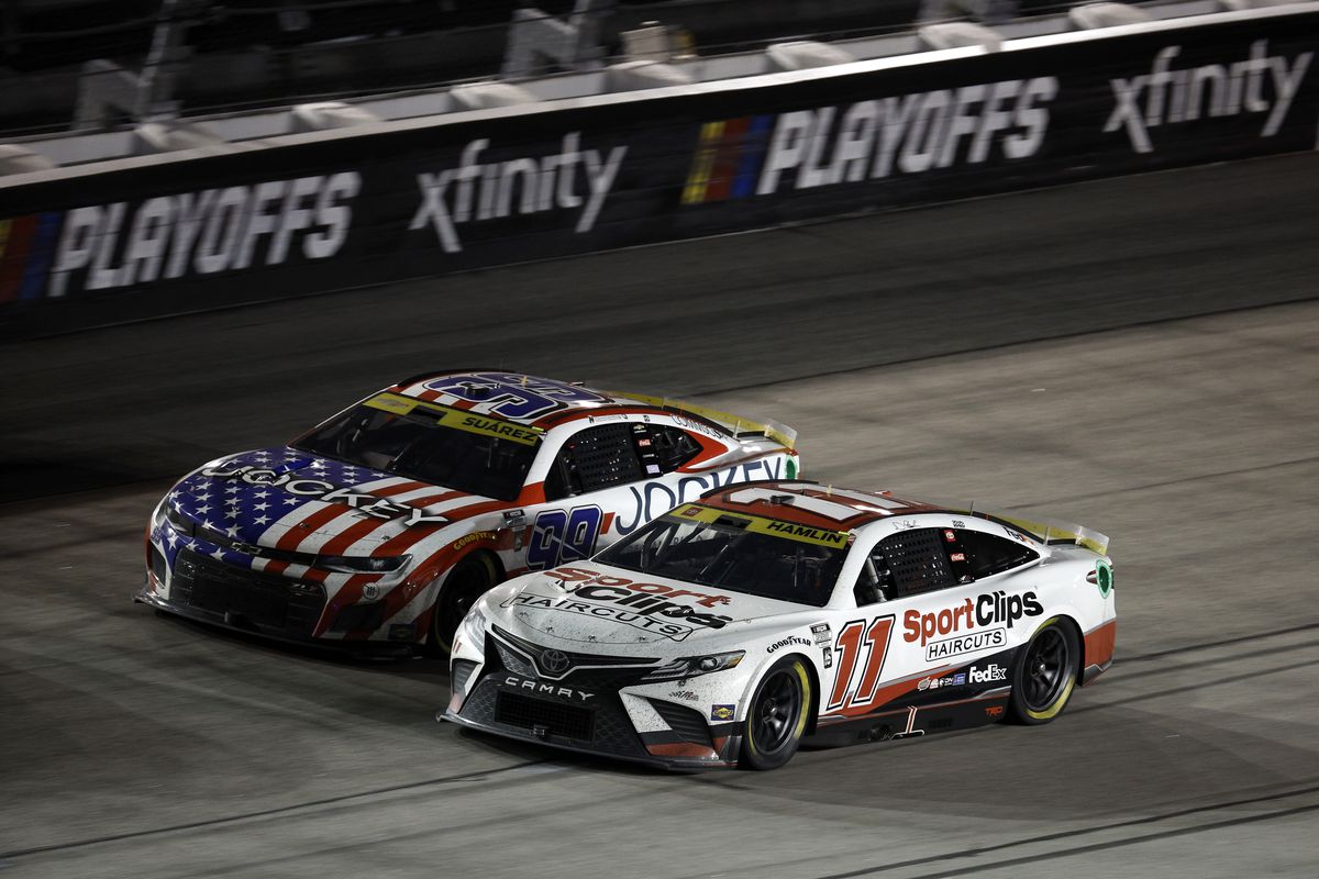 Denny Hamlin, driver of the #11 Sport Clips Haircuts Toyota, and Daniel Suarez, driver of the #99 Jockey Chevrolet, race during the NASCAR Cup Series Cook Out Southern 500 at Darlington Raceway on September 04, 2022 in Darlington, South Carolina.