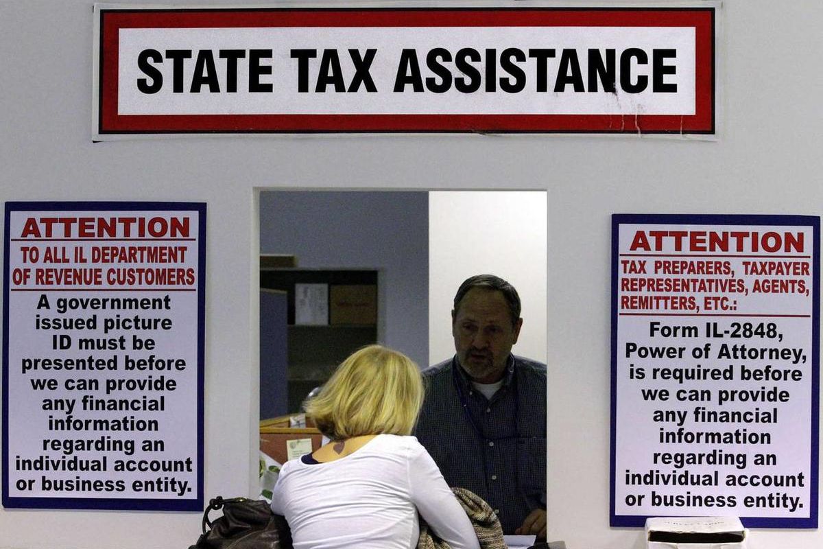 In this 2012 file photo, an employee offers assistance to taxpayers at the Illinois Department of Revenue, in Springfield, Ill. This year, the most Americans since 2001 are not satisfied with the rates they are paying in income taxes.