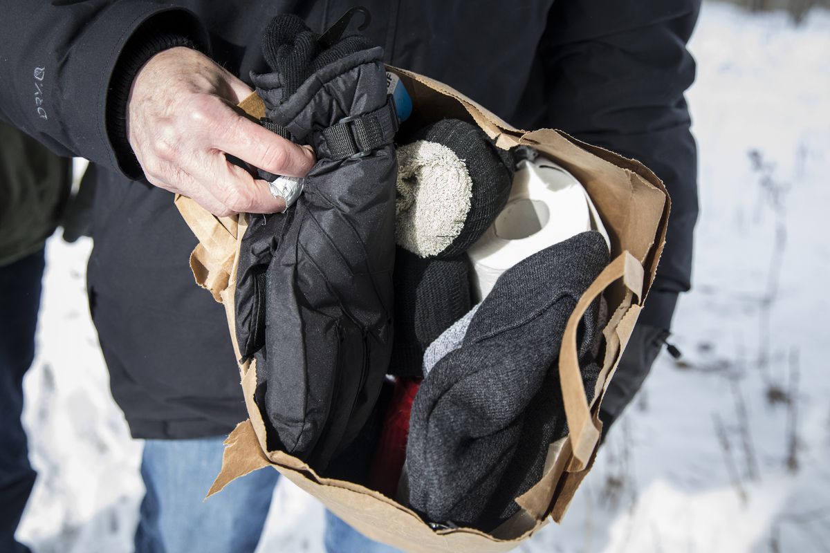 Ralph Ryan, a doctor and volunteer member of The Night Ministry’s Street Medicine Outreach Team, shows a bag of supplies the team is providing to a man living inside a tent in a homeless encampment on the Southwest Side. | Ashlee Rezin/Sun-Times