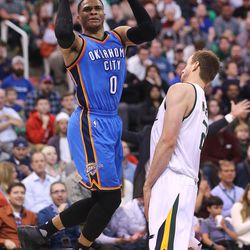 Oklahoma City Thunder guard Russell Westbrook (0) shoot after drawing a foul on Utah Jazz forward Joe Ingles (2) as the Jazz and the Thunder play at Vivint Smart Home arena in Salt Lake City on Wednesday, Dec. 14, 2016.