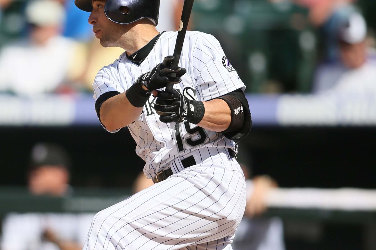 July 18, 2012; Denver, CO, USA; Colorado Rockies second baseman Marco Scuatro hits a single during the eighth inning against the Pittsburgh Pirates at Coors Field.  The Pirates won 6-9.  Mandatory Credit: Chris Humphreys-US PRESSWIRE