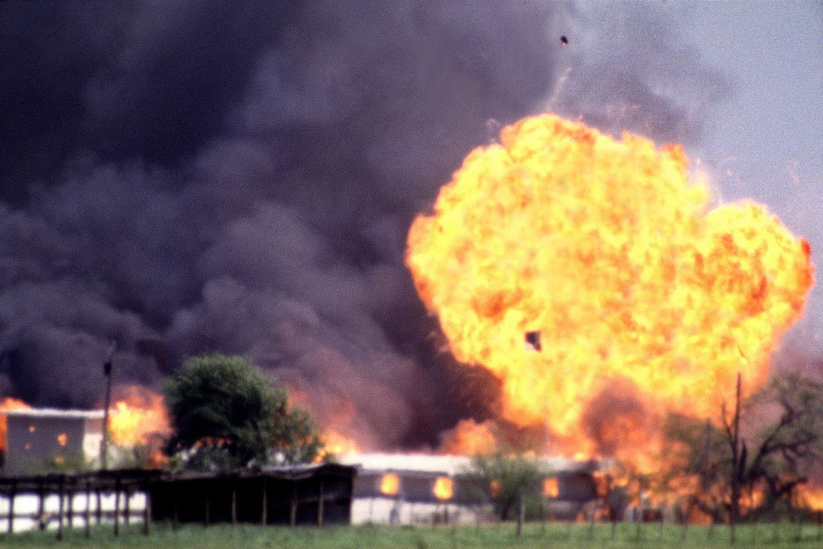 A building explodes in a plume of fire.