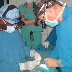 Dr. Robert Hoffman, a pediatric eye surgeon, and a Ghanaian colleague perform surgery at KATH.