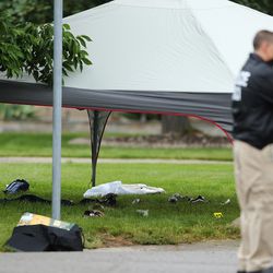 Evidence is covered as police investigate an officer-involved shooting of an armed robbery suspect in Cottonwood Heights on Tuesday, May 29, 2018.