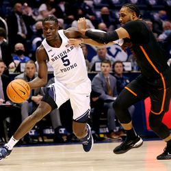 Brigham Young Cougars forward Gideon George (5) is pushed by Pacific Tigers guard Alphonso Anderson (10) as he drives to the hoop as BYU and Pacific play in an NCAA basketball game in Provo at the Marriott Center on Thursday, Jan. 6, 2022. BYU won 73-51.