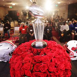 The Rose Bowl trophy and team helmets are displayed during a press conference in Los Angeles on Friday, Dec. 31, 2021.