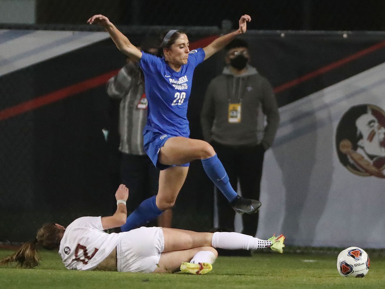 BYU forward Cameron Tucker and Florida State Seminoles Heather Payne compete during the NCAA national soccer championship.