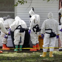 In this Friday, April 19, 2013 file photo, federal agents wearing hazardous material suits inspect a trash can outside the house of Paul Kevin Curtis in Corinth, Miss. Curtis is in custody under the suspicion of sending letters covered in ricin to U.S. President Barack Obama and U.S. Sen. Roger Wicker, R-Miss. Event after nail-biting event, America was rocked this week, in rare and frightening ways, with what felt like an unremitting series of tragedies.