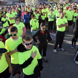 A huge crowd of runners gather to sing the National Anthem prior to the start of a 5K race to remember and support the victims of the Boston Marathon bombings, as Striders Running Store in Layton Monday, April 22, 2013.
