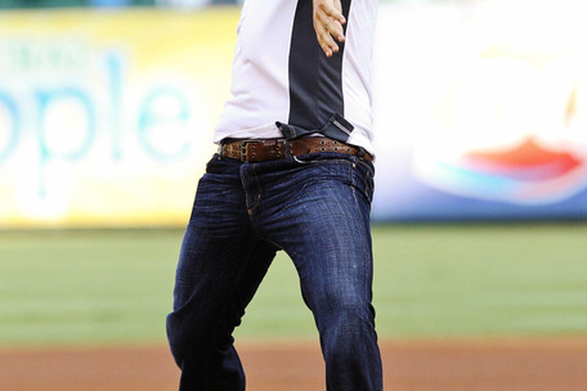 May 30, 2012; Arlington, TX, USA; Dallas Cowboys quarterback Tony Romo throws out the ceremonial first pitch before the game between the Texas Rangers and the Seattle Mariners at Rangers Ballpark.  Mandatory Credit: Kevin Jairaj-US PRESSWIRE