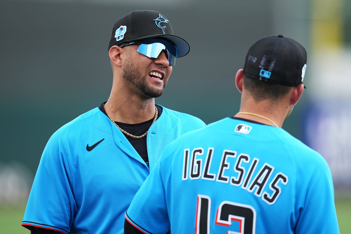 Miami Marlins designated hitter Yuli Gurriel (97) talks with Miami Marlins shortstop Jose Iglesias (13) before the game against the New York Mets at Roger Dean Stadium.