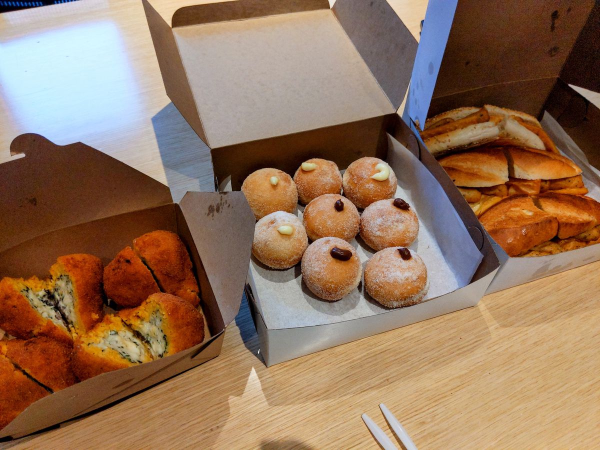 Three boxes full of pastries.