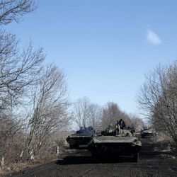 Ukrainian army armored vehicles ride on a road towards Debaltseve near the town of Artemivsk, Ukraine, Friday, Feb. 13, 2015. The fighting between Russia-backed separatists and Ukrainian government forces has continued despite the agreement reached by leaders of Russia, Ukraine, Germany and France in the Belarusian capital of Minsk on Thursday. Much of the fighting had taken place near Debaltseve, a key transport hub that has been hotly contested in recent days. The leaders agreed to implement a cease-fire, set to take effect on Sunday, at one minute after midnight. 