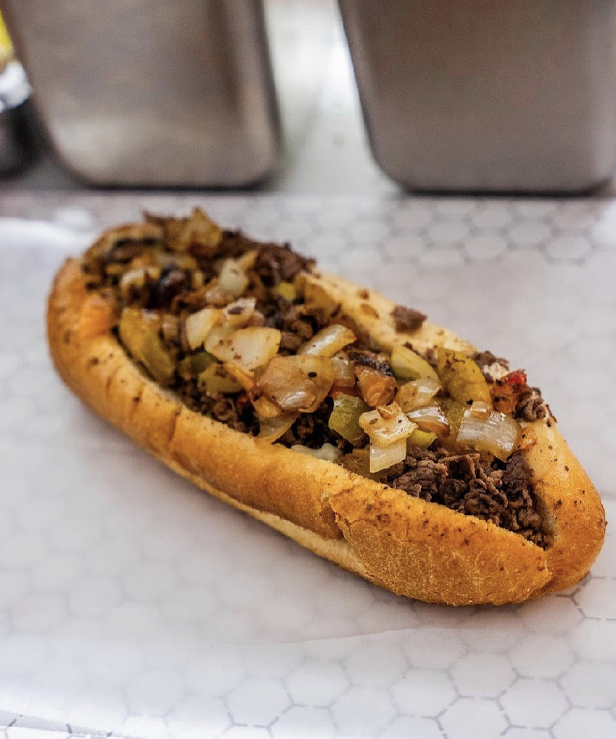 A cheesesteak on a serving table. 