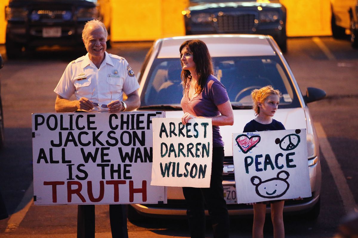 Demonstrators protest the shooting death of Michael Brown in Ferguson, Missouri.