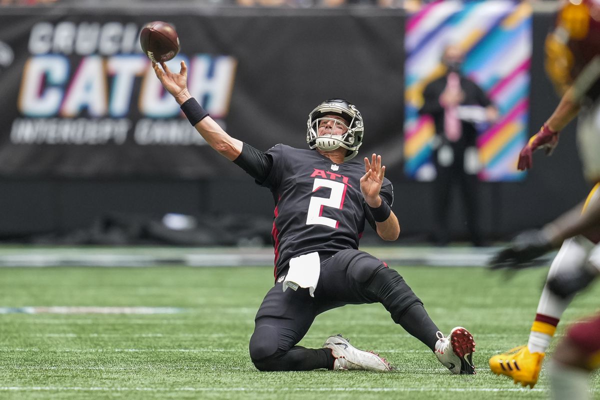 Atlanta Falcons quarterback Matt Ryan (2) tries to pass after being hit by Washington Football Team defensive end Chase Young (99) (not shown) during the second half at Mercedes-Benz Stadium.