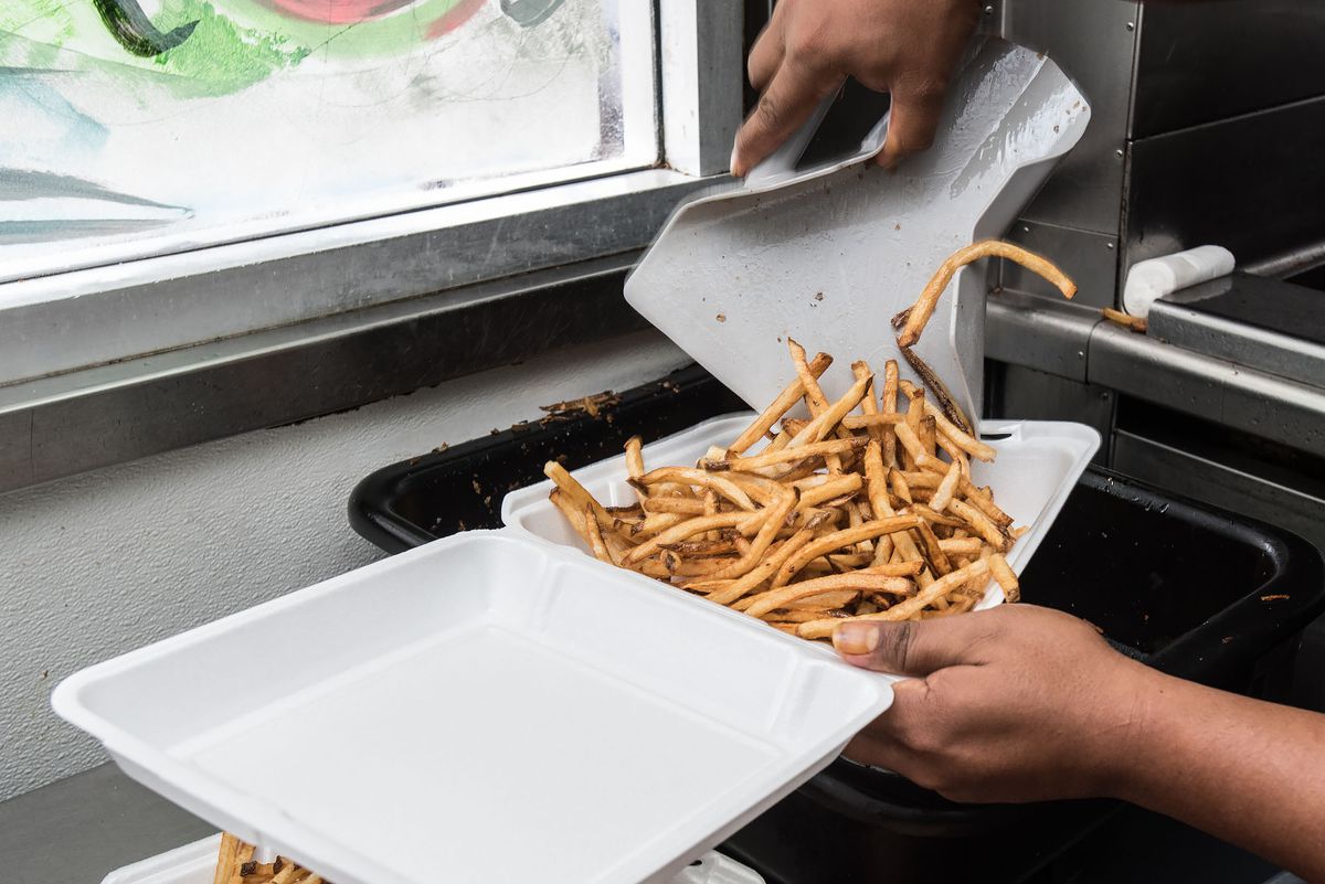 Fries from Dino’s in Pico-Union being poured into a tray.