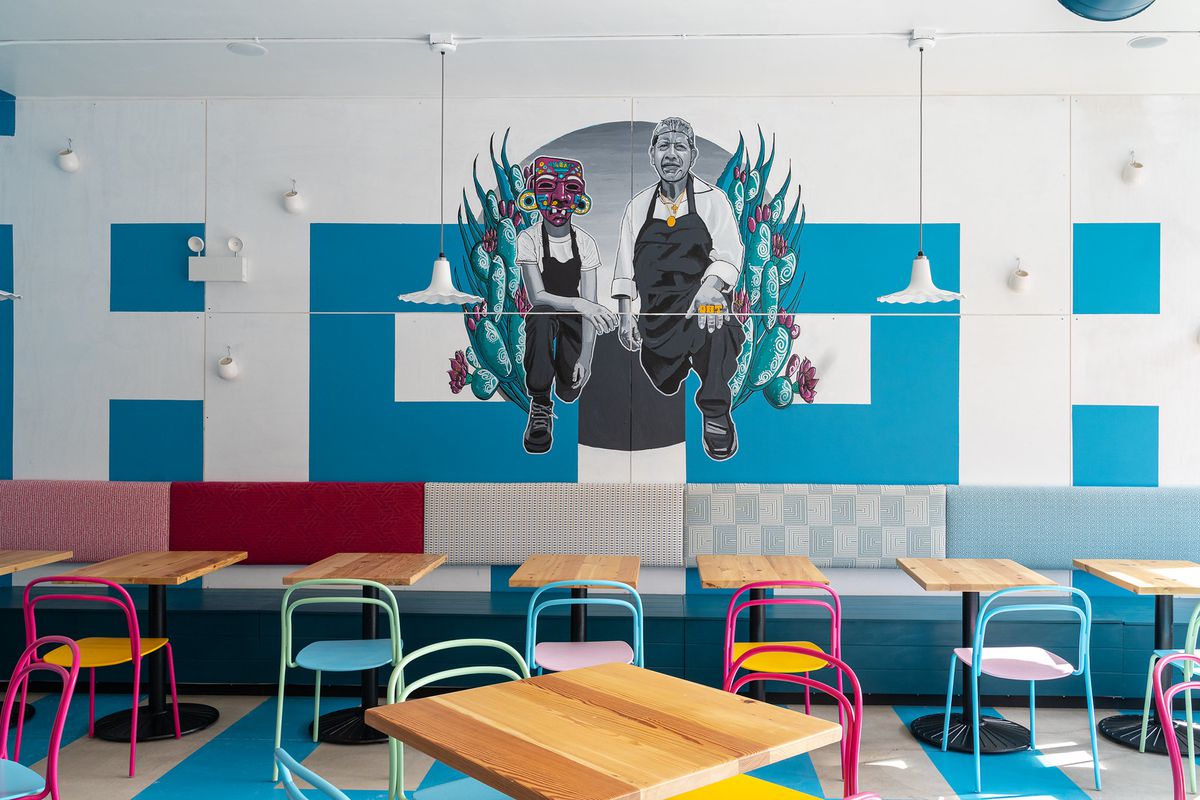 A restaurant’s back wall with a mural.