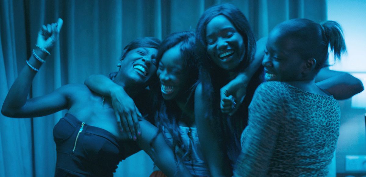 The cast of Girlhood laughing and singing karaoke together