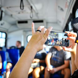 Melissa Hansen takes a group photo on the bus during the Continue Mission event in Tibble Fork in American Fork Canyon on Aug. 17, 2017. The veterans get together with each other and their families to enjoy the outdoors, get some exercise and just have fun.