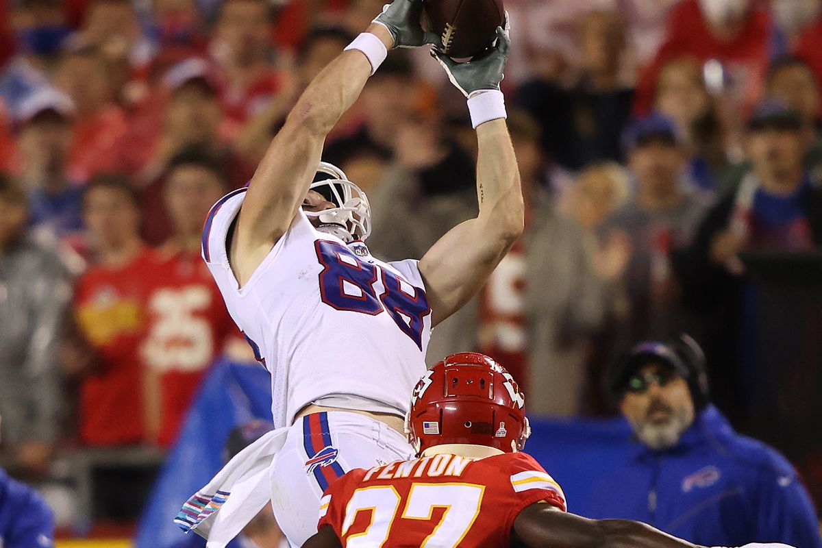 Dawson Knox #88 of the Buffalo Bills makes a reception past the defense of Rashad Fenton #27 of the Kansas City Chiefs during the second half of a game at Arrowhead Stadium on October 10, 2021 in Kansas City, Missouri.