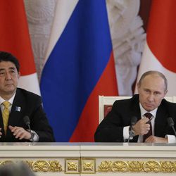 Russian President Vladimir Putin, right, speaks at a final news conference alongside visiting Japanese Prime Minister Shinzo Abe in Moscow's Kremlin, Monday, April 29, 2013. Abe is in Russia on an official visit. 